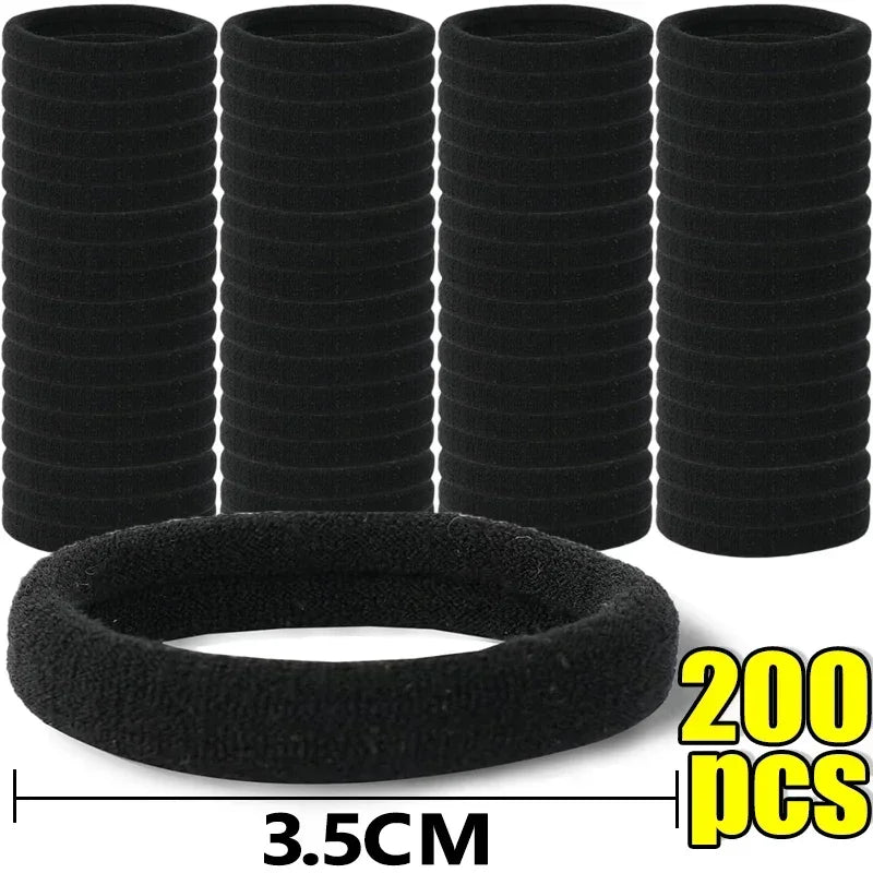 A set of five black elastic hair bands stacked vertically and one circular band shown below with a measurement of 3.5cm