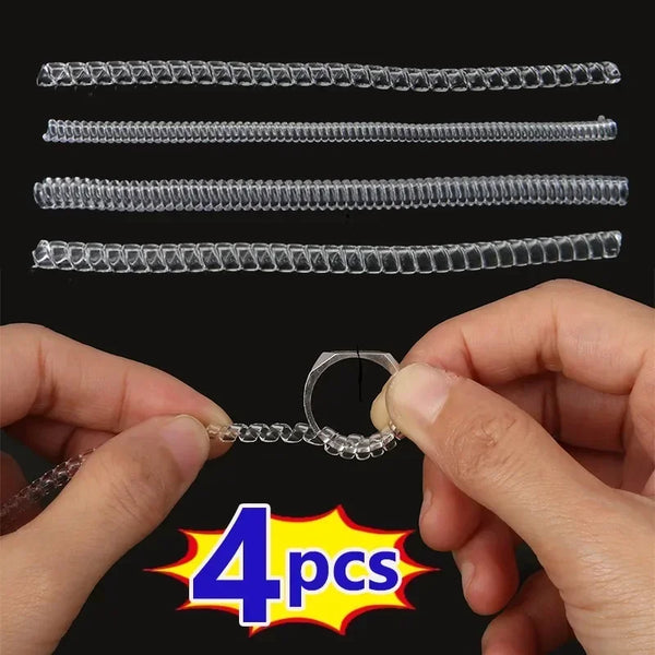 A set of four clear invisible ring size adjusters is shown being held by a hand.