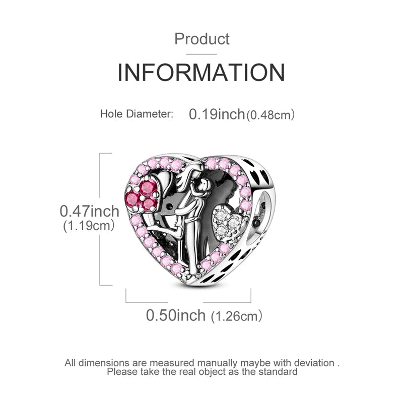 A sterling silver heart-shaped charm featuring a silhouette of a couple and pink stones.