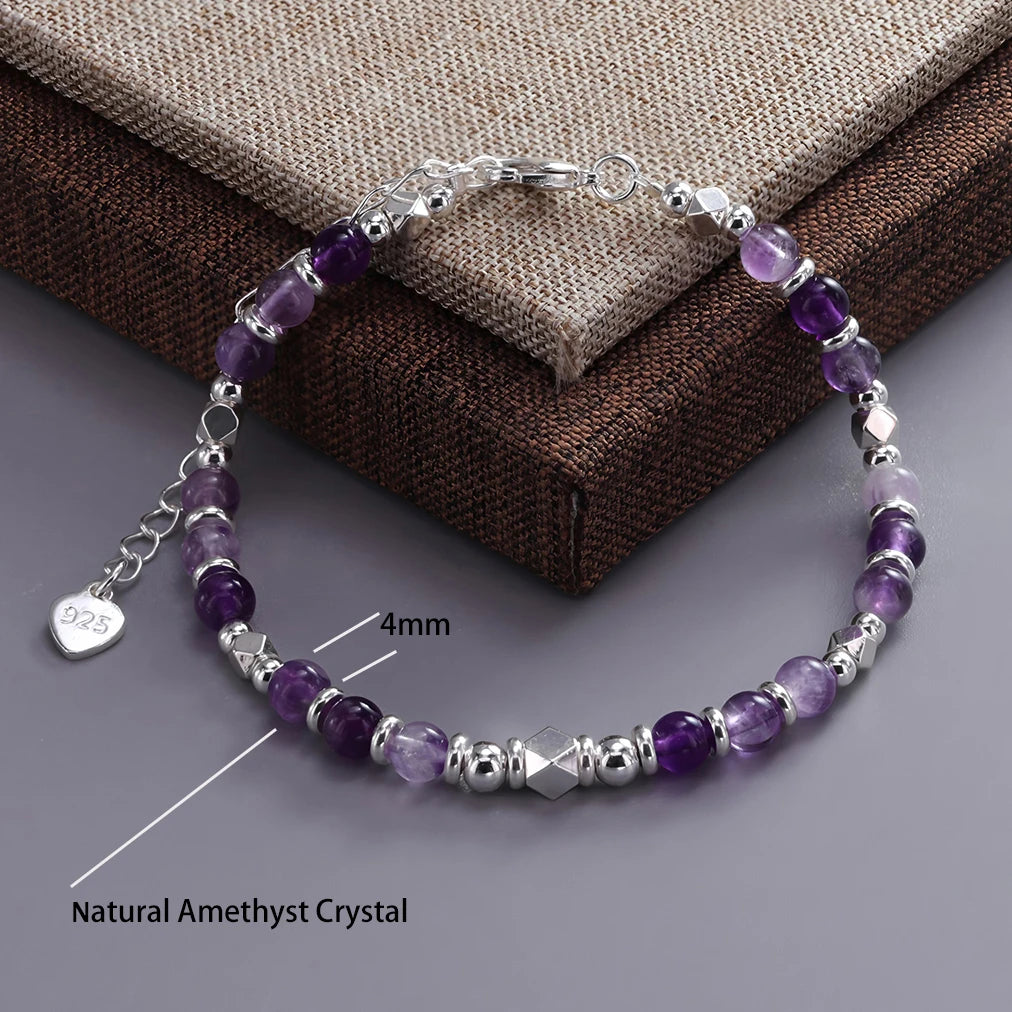 Sterling silver double heart charm bracelet featuring purple amethyst crystals on a silver chain