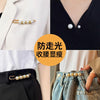 Close-up of pearl brooch pins being used to customize a white blazer and denim fabric.