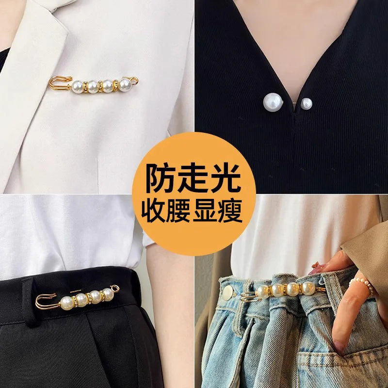 Close-up of pearl brooch pins being used to customize a white blazer and denim fabric.