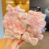Pink fabric flower bow hair ties for girls with various shades and textures