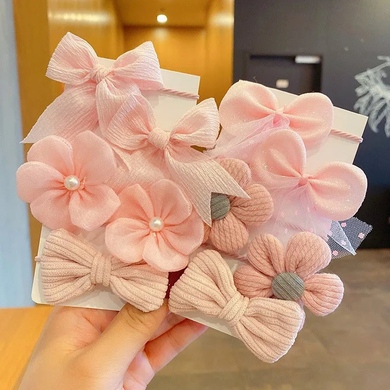 Pink fabric flower bow hair ties for girls with various shades and textures