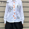 White long-sleeved shirt with a goldfish print tie and decorative ink designs
