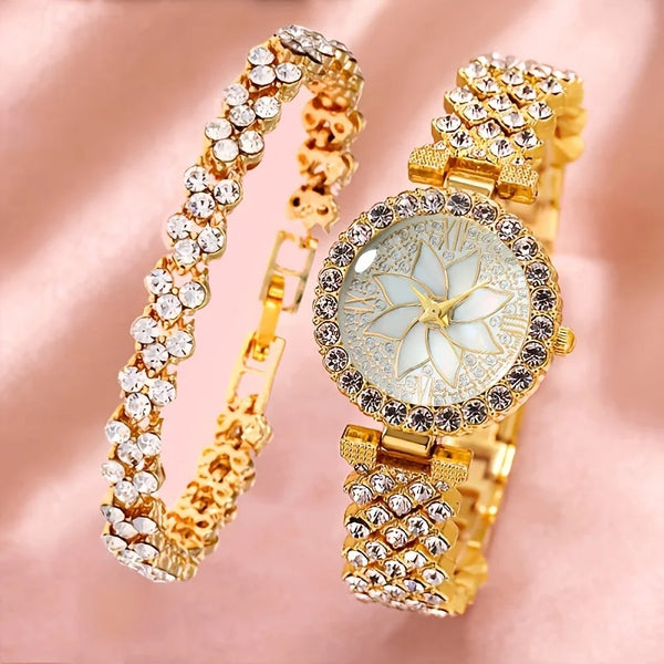 A gold-toned watch and bracelet set adorned with clear rhinestones and featuring a white floral design on the watch face.