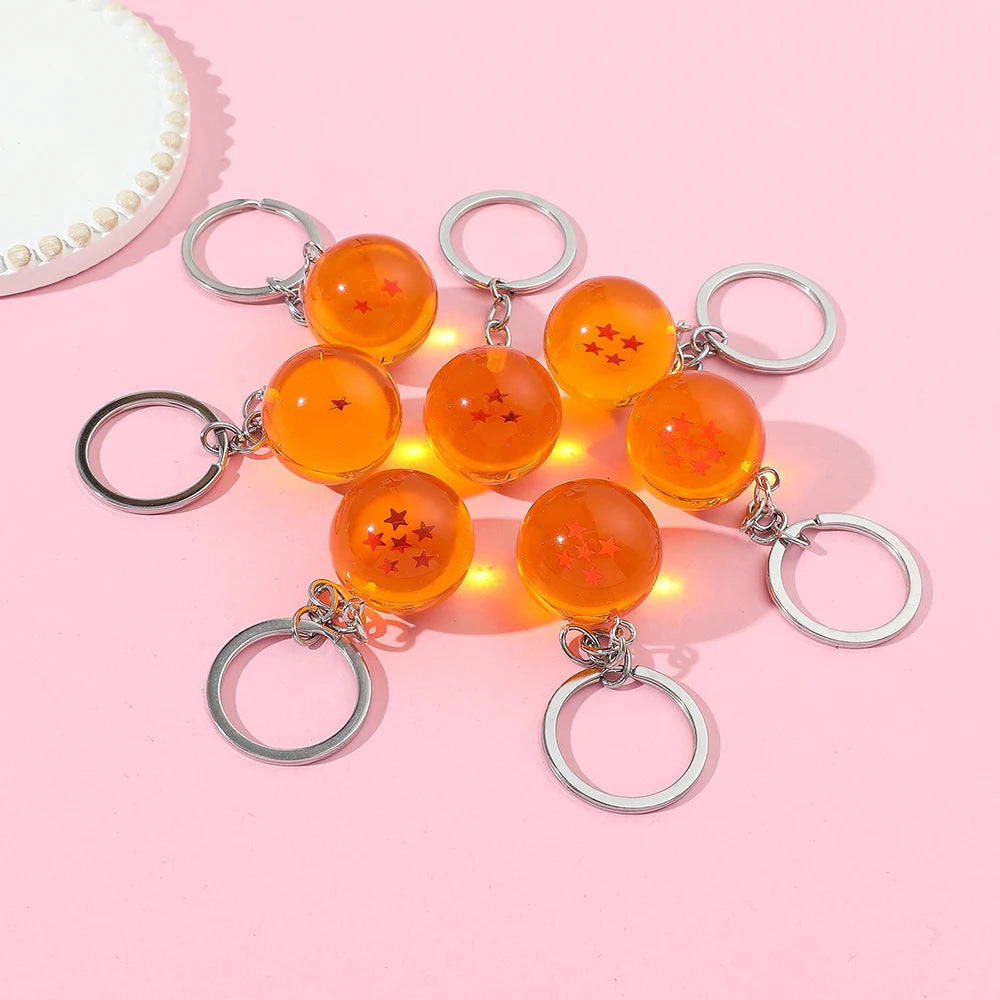 A set of orange glass beads with silver rings used as an anime star keychain for a car keyring.