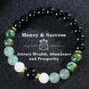 A black beaded bracelet featuring green and white stones for attracting wealth, abundance, and prosperity.