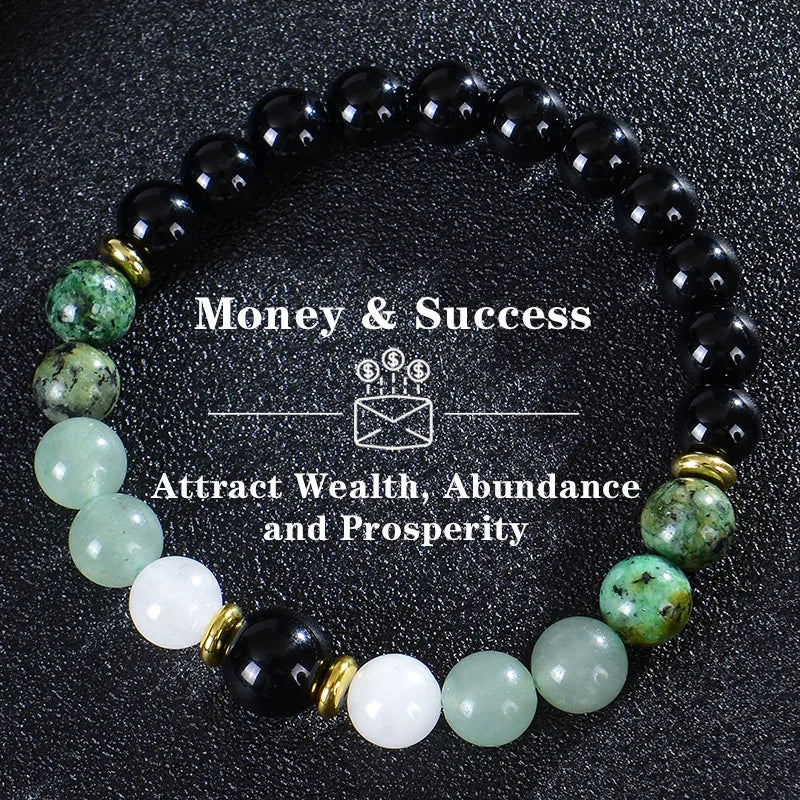 A black beaded bracelet featuring green and white stones for attracting wealth, abundance, and prosperity.