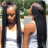 Close-up of a woman with long black braided cornrow hair showcasing the texture and style.