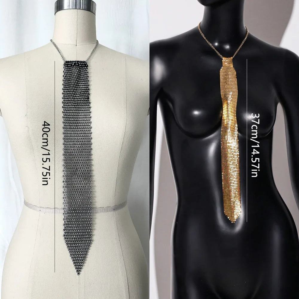 A close-up of a long, shimmering gold crystal rhinestone sequin necklace displayed on a mannequin.