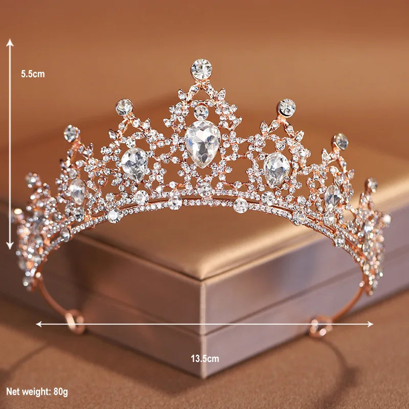 A delicate rose gold crystal baroque bridal tiara headpiece displayed on a box with dimension markings.