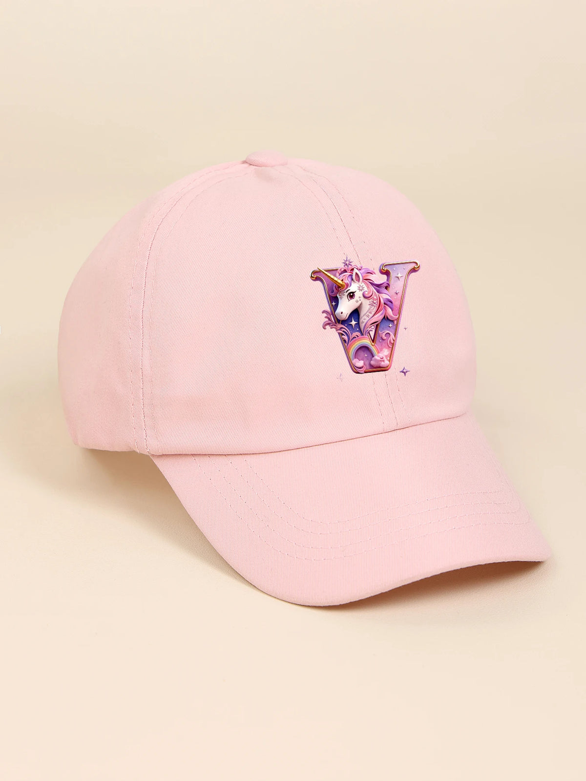 A pink baseball cap featuring a colorful unicorn design on the front.