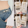 A close-up of pearl and gemstone brooch pins displayed on white cards, showing various styles for customizing apparel.