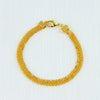 A gold-colored chain necklace with a clasp and a matching bracelet, displayed on a white background.
