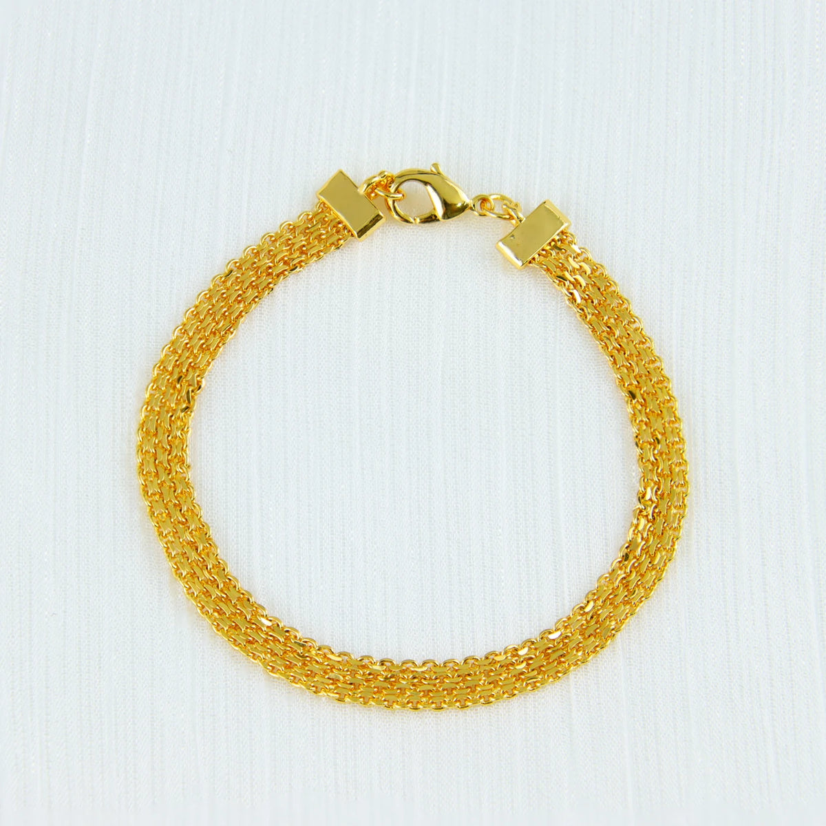A gold-colored chain necklace with a clasp and a matching bracelet, displayed on a white background.
