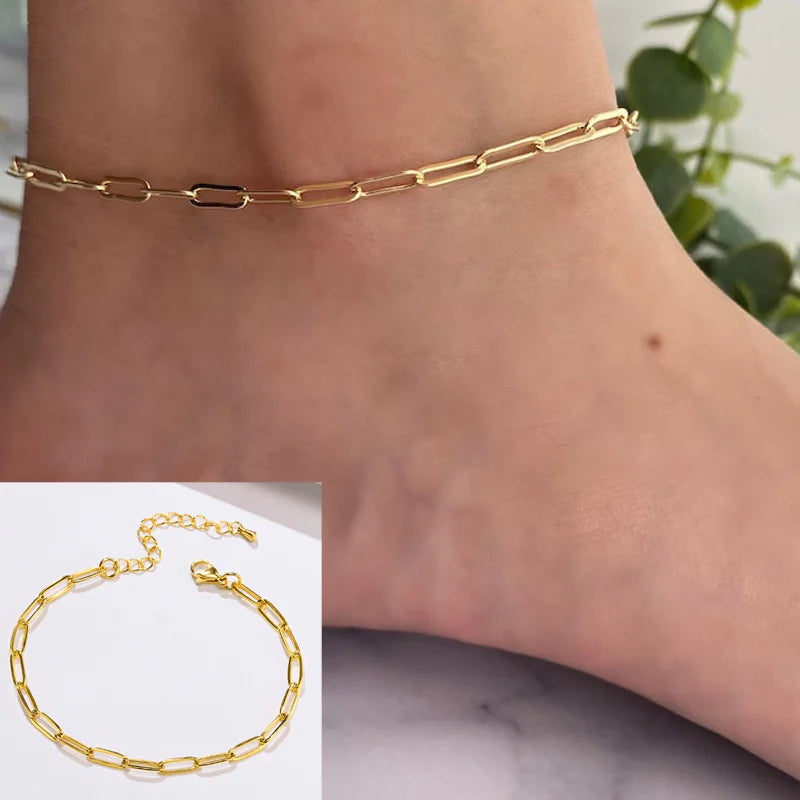 Gold stainless steel snake chain anklet worn on a woman's ankle.