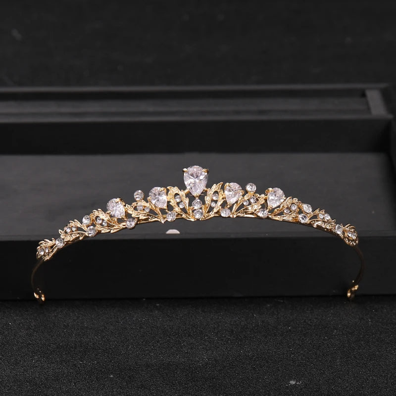 Gold-toned bridal tiara headpiece adorned with clear crystals and rhinestones displayed in a black box.