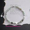 Sterling silver double heart charm bracelet featuring natural Burmese jade stones and silver accents