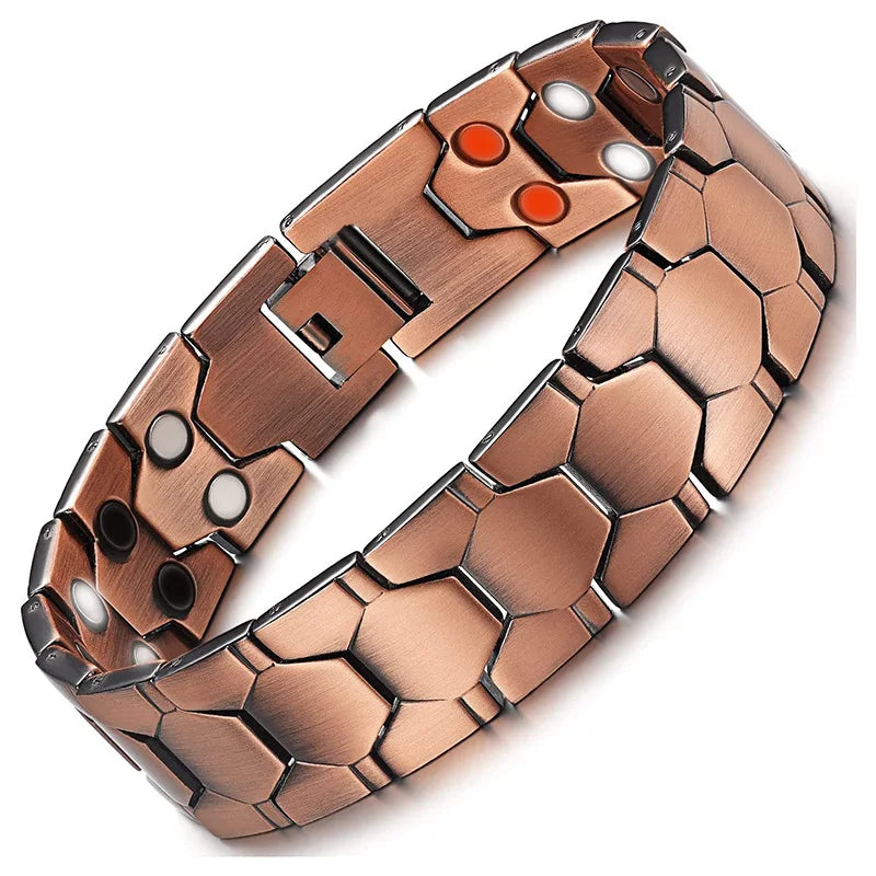 A close-up view of a copper magnetic therapy bracelet with hexagonal links and small white and orange dots.