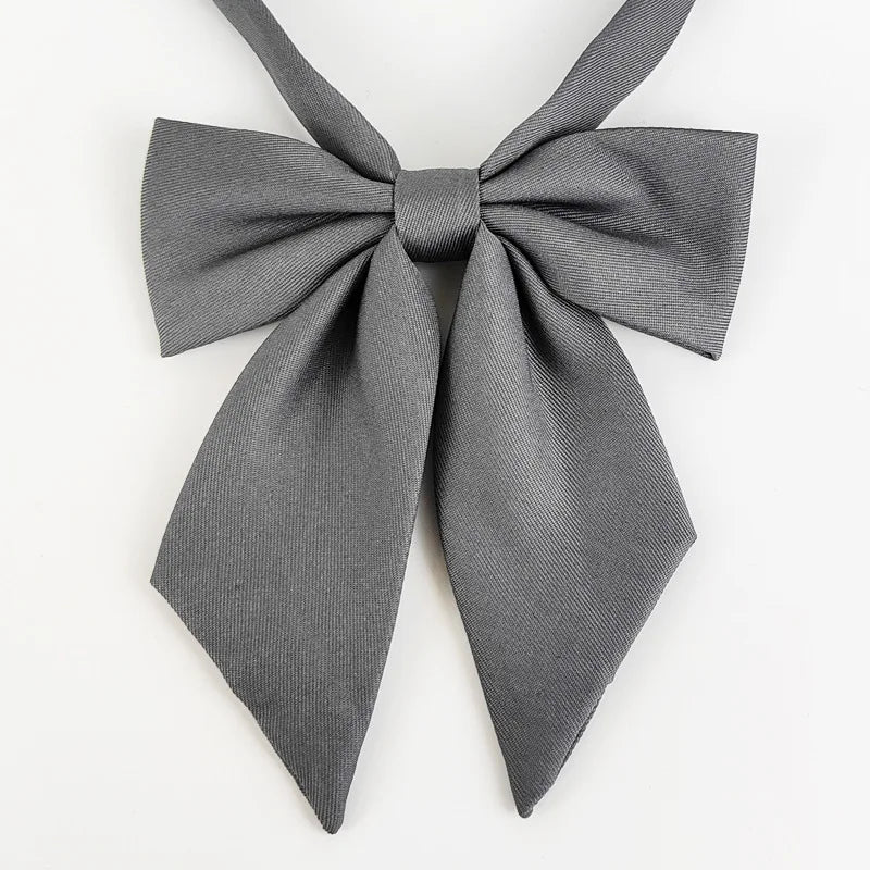 A gray fabric butterfly ribbon tie set tied in a bow.