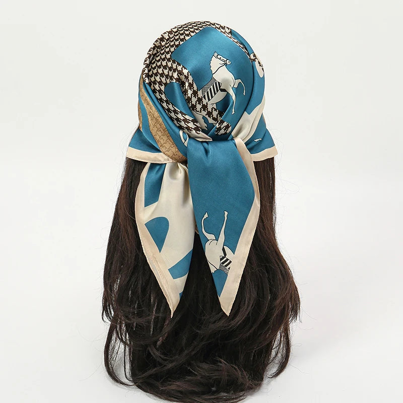A blue silk scarf tied around a dark hair, featuring a patterned fabric with a white horse design.