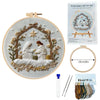 Embroidery DIY Art Kit featuring a circular design of a woman and a bird in a wreath with embroidery threads and needles