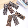 A collection of leopard print fashion headbands for yoga and sports displayed on a white background.