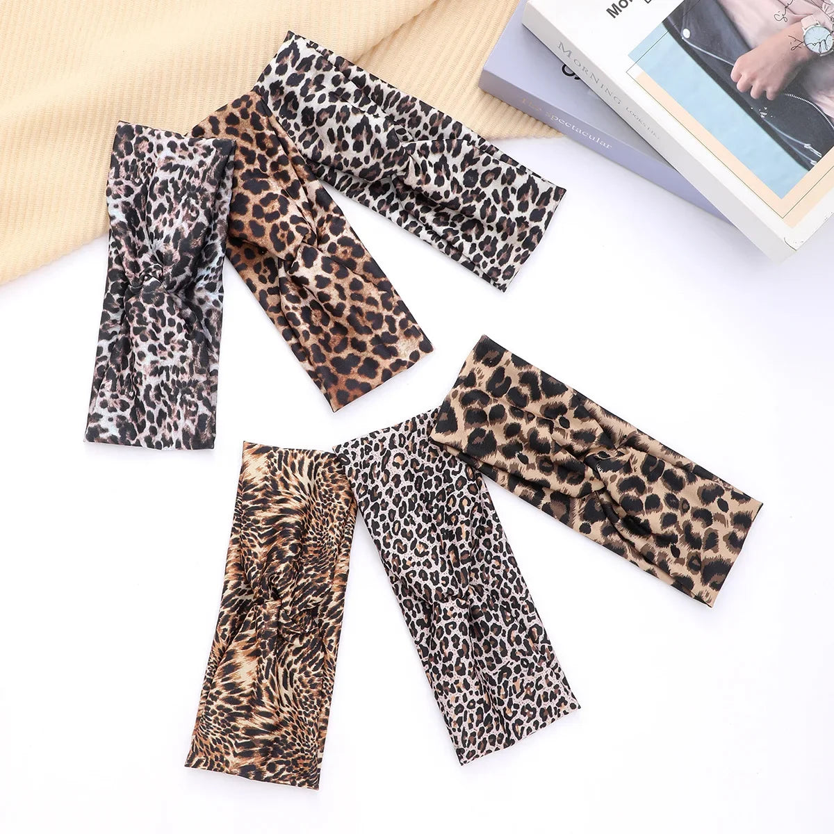 A collection of leopard print fashion headbands for yoga and sports displayed on a white background.