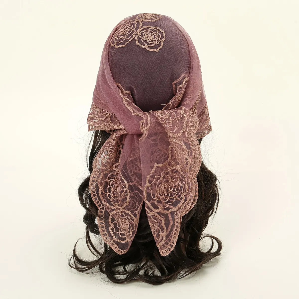 A dark purple floral embroidered lace bandana headscarf tied around a person's hair.