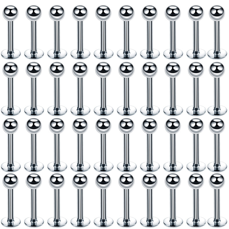 A grid of silver stainless steel labret lip rings for piercings.