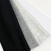 A stack of four knitted hair bands in black, gray, and white colors.