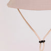 A beige letter print sun hat for kids with a light pink fabric and a thin strap.