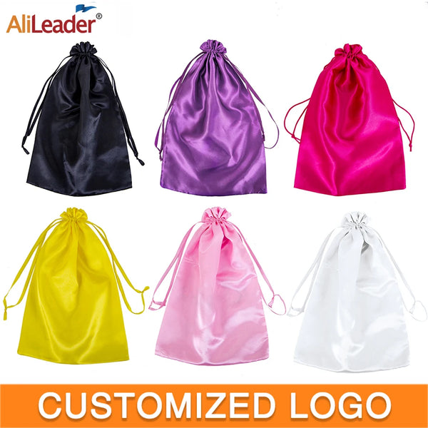 A collection of satin wig storage bags in black, purple, pink, yellow, and white with drawstrings.