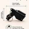 A black tactical pistol keychain with a detachable holster, shown in a side view.