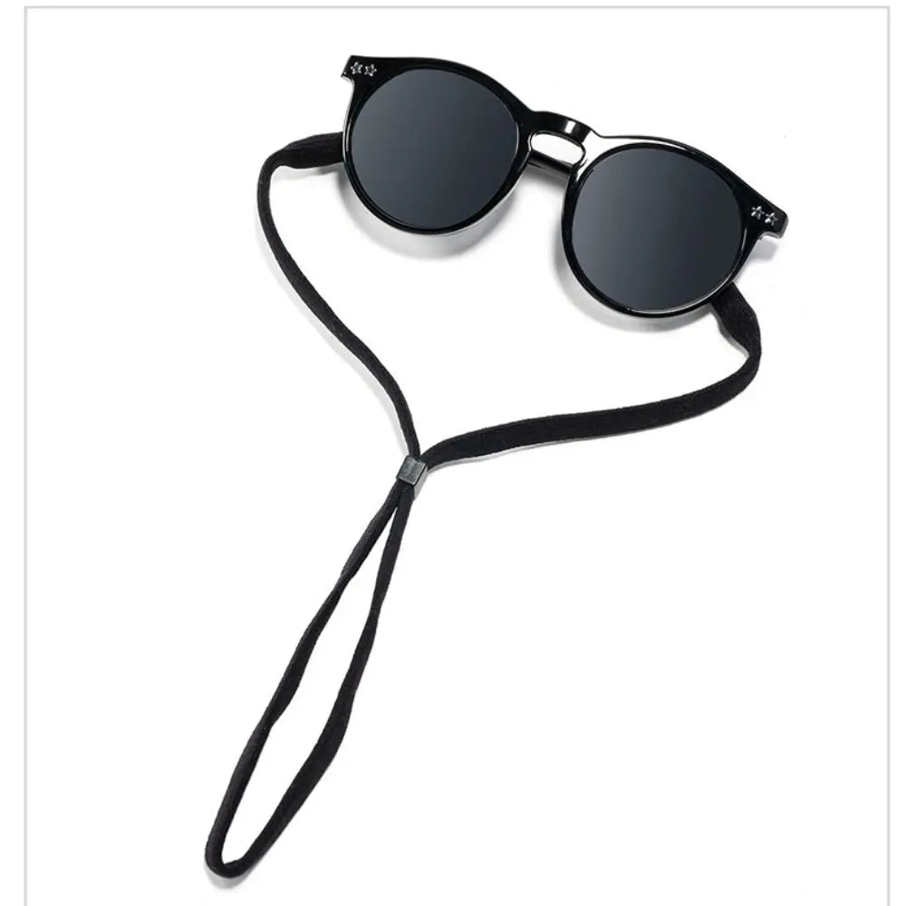 Black sunglasses with a black adjustable lanyard necklace
