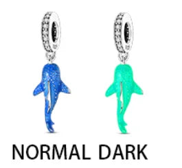 Sterling silver devil's eye charm bracelet featuring a dark blue and green fish pendant.