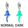 Sterling silver devil's eye charm bracelet featuring a dark blue and green fish pendant.