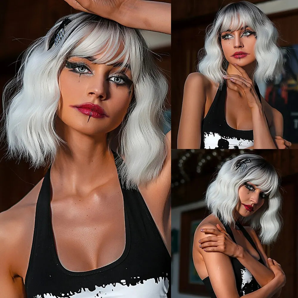 A woman with short wavy platinum blonde hair and dark makeup wearing a black top.