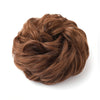 A close-up of a large messy bun hairstyle made from brown hair.