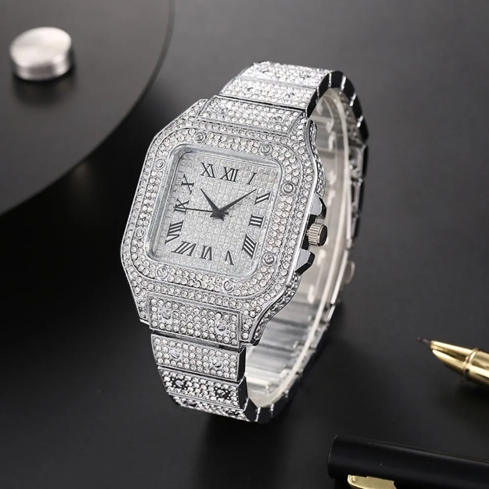 A silver-toned luxury men's quartz business watch with a diamond-encrusted bezel and bracelet, displayed on a dark surface.