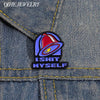 A vintage enamel pin featuring a red bell design with the text ISHIT MYSELF on a denim fabric background.