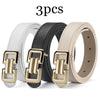 Three belts in white, black, and beige leather with gold-tone buckles displayed together.