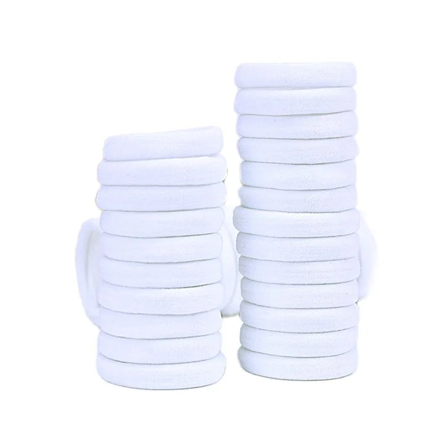 A stack of white elastic hair bands.
