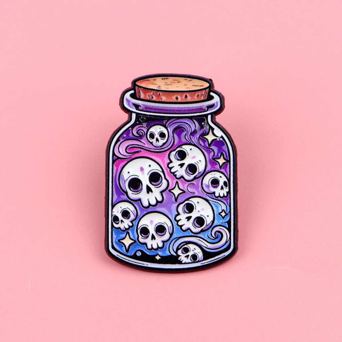 A dark purple enamel pin shaped like a skull with swirling patterns, set in a glass jar.