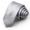 A folded silver satin neck tie for formal wear.