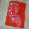 A pair of flexible clear eye shields packaged in red plastic.
