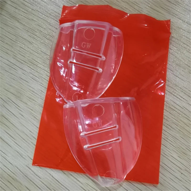 A pair of flexible clear eye shields packaged in red plastic.