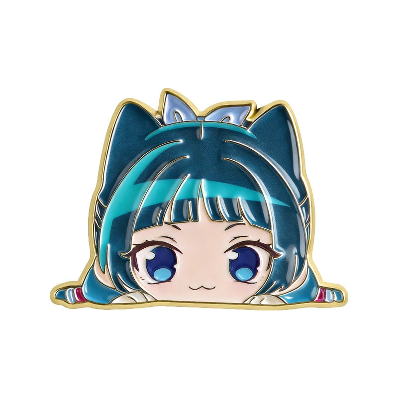A cute anime character brooch featuring blue hair and large eyes with teal accents.
