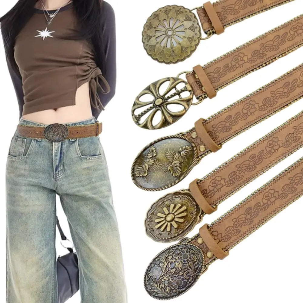 A close-up of a vintage PU leather boho western belt with ornate silver and brown detailing.